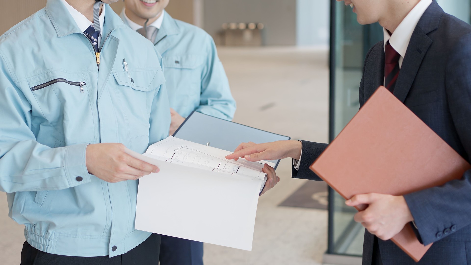 A man in work clothes having a meeting with a client